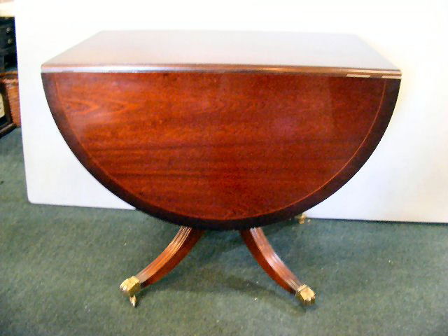 Mahogany inlaid drop table with Duncan Phyfe legs: Mahogany inlaid drop table with Duncan Phyfe legs, scratches, small piece of missing inlay, 30" high, 36.25" wide, 23" deep and 59.25" long extended