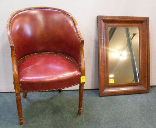 Leather upholstered arm chair, cracks in seat and: Leather upholstered arm chair, cracks in seat and ogee mirror 22.5" X 32.5" small veneer chip