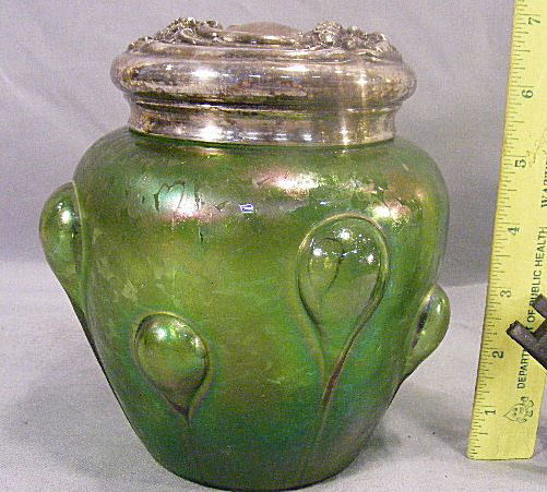Loetz type art nouveau glass humidor with silver: Loetz type art nouveau glass humidor with silver plate lid. Lid is 6.5" high with small pin holes in top. Jar has a few small flecks on neck.