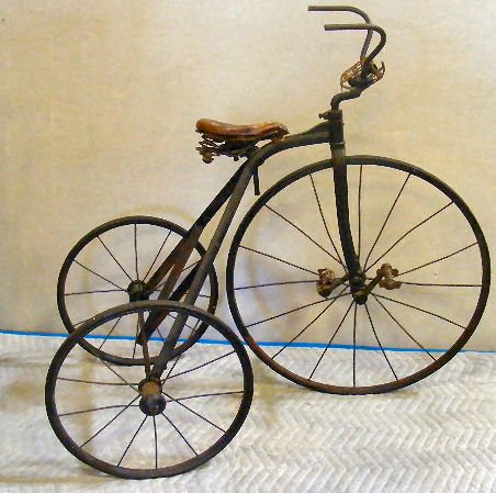 Antique tricycle, very good structural condition, : Antique tricycle, very good structural condition, one peddle missing and loose odd peddle does not match , original leather seat, one broken spoke, manufacturer tag missing, 35" high to top of handle 