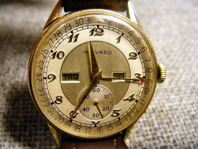 Movado 14K gold calendar watch, 17 jewels, engrav: Movado 14K gold calendar watch, 17 jewels, engraved on back of case "DCT December 1951" running