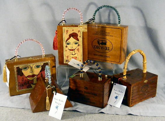 Cigar box purses by Katie Bisbee Designs, creative: Cigar box purses by Katie Bisbee Designs, creative one-of-a-kind purses. Beaded handles, fabric lined interiors and a compact mirror. 2 with decoupage. Total of 6 hand bags. Tallest measures 10.5"