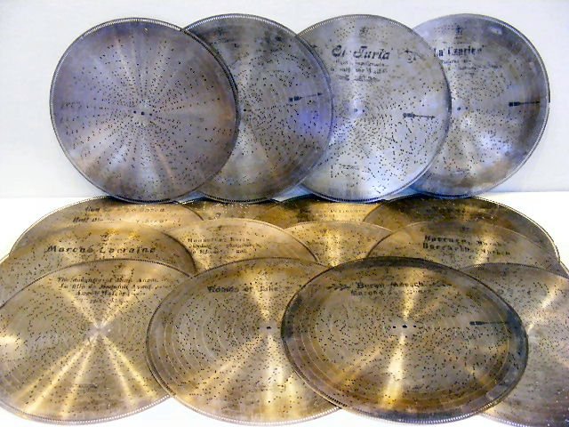 16pcs. Circa 1890's Stella steel music box disc's/: 16pcs. Circa 1890's Stella steel music box disc's/ tune sheets, stamped Stella in middle w/ some printed song titles, 17.25" diameter. Swiss.