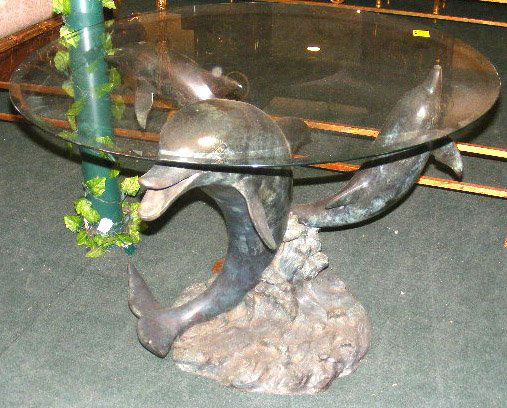 Glass top table with brass dolphin base, 28" high: Glass top table with brass dolphin base, 28" high, 40" diameter