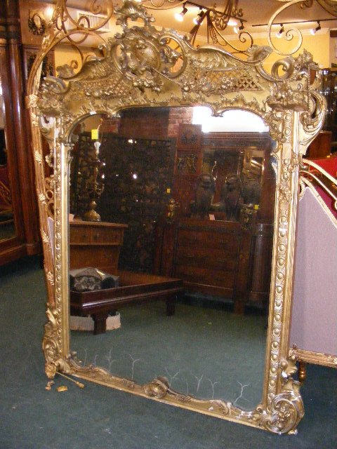 Large antique gilded mirror, several areas of dam: Large antique gilded mirror, several areas of damage and lost pieces, 64" X 80"