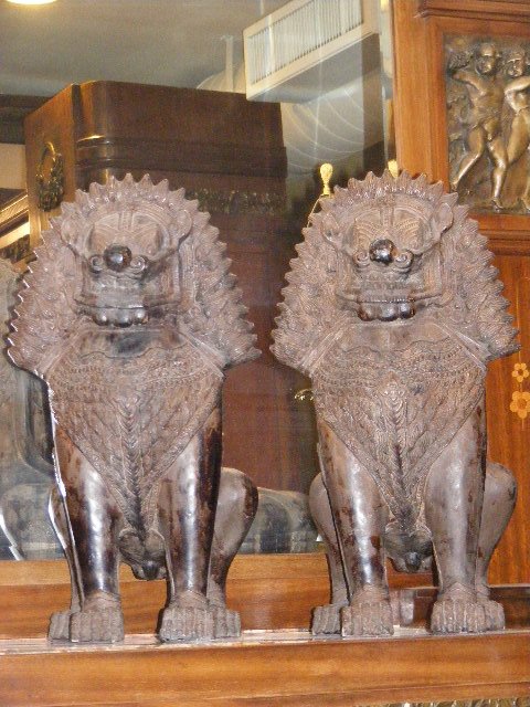 Pair of dark patina white metal Asian dogs, 21" h: Pair of dark patina white metal Asian dogs, 21" high. Repair on back leg of one dog.