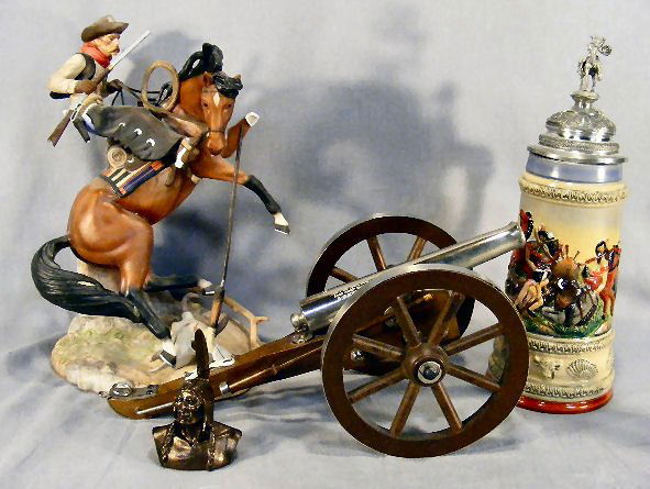 Lot including Jim Ponter porcelain figurine (one l: Lot including Jim Ponter porcelain figurine (one leg on horse broken), Spanish black powder toy cannon, Thewalt stein with native American theme (dent in lid) and small bust of native American.