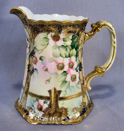 Nippon porcelain 8" pitcher with dogwood decoratio: Nippon porcelain 8" pitcher with dogwood decoration, minimal gold wear, no chips or cracks
