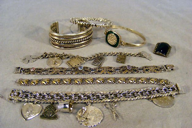 Lot including 2 sterling silver charm bracelets, : Lot including 2 sterling silver charm bracelets, cuff bracelet, marcasite bracelet, etc., total weight 6.43 troy ounces with stones.