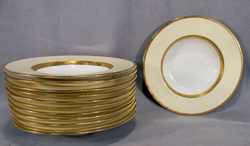 12 Mintons K 100 cream & gold rimmed soups, 9" dia: 12 Mintons K 100 cream & gold rimmed soups, 9" diameter, minimal utensil marks, very minor to no gold wear, chip on edge of one, chip on foot of one, no other chips or cracks