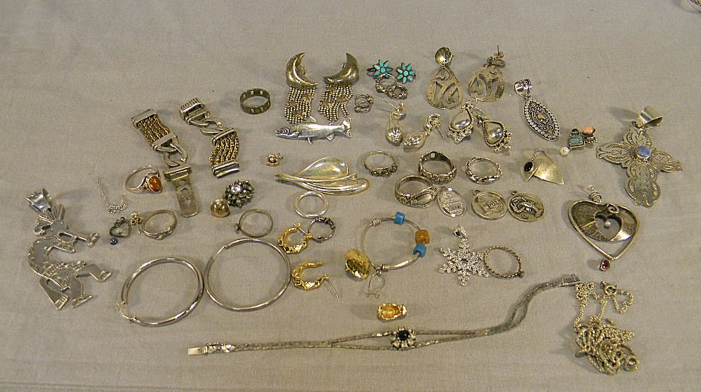 Lot of sterling silver including rings, bracelets,: Lot of sterling silver including rings, bracelets, earrings, pins, watch band, scrap, etc., some small unmarked odd pieces may not be sterling. 7.77 troy ounces total weight