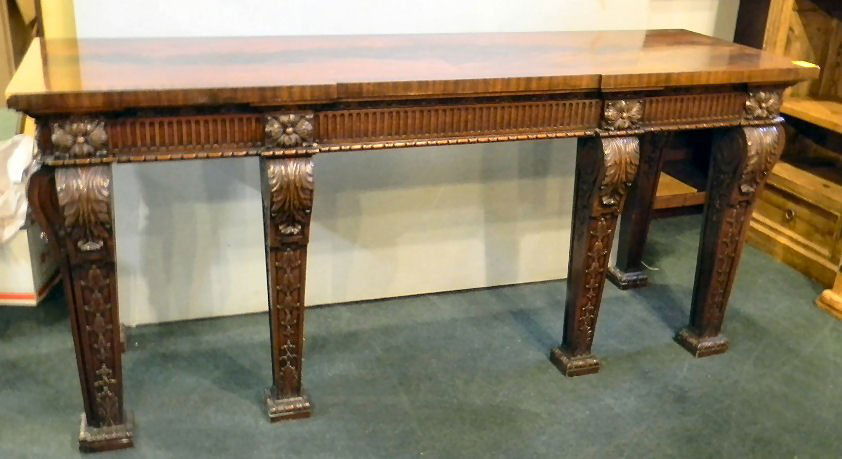 Mahogany server with three drawers, flame mahogan: Mahogany server with three drawers, flame mahogany veneered top, heavily carved legs, both corners chipped on one end, 78" long, 24" deep and 35" high
