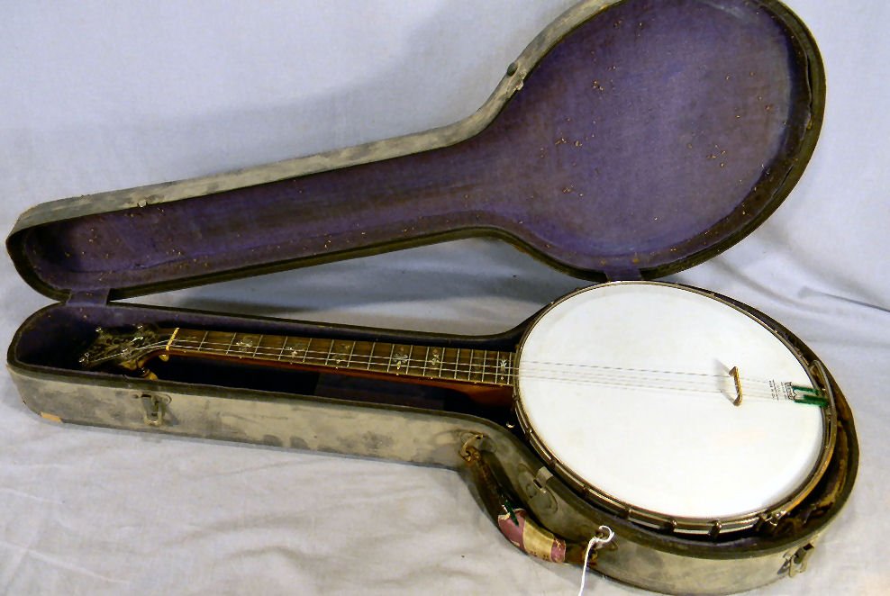 Estate Orpheum No. 1 four string ,banjo with moth: Estate Orpheum No. 1 four string ,banjo with mother of pearl inlaid finger board, some inlay missing, section of back edge is lifting shown in photos, 29.5" long, original case is rough.