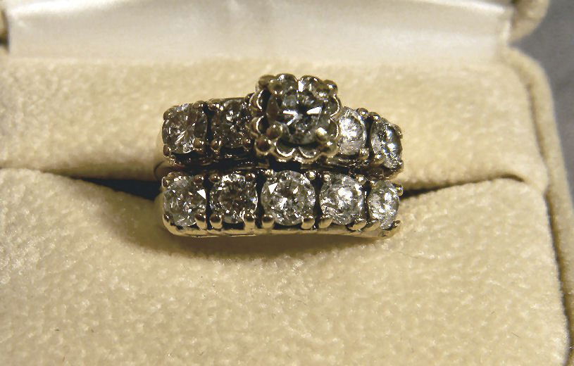 One piece wedding ring set (soldered) yellow 14K: One piece wedding ring set (soldered) yellow 14K gold. Size 5.75. Center 1/2 carat diamond with two 20pt Diamonds on each side. Band has 5 diamonds approx. 20pts each. No chips or cracks. Total weight