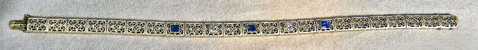 Rhodium plated 14k Art Deco bracelet, sapphire co: Rhodium plated 14k Art Deco bracelet, sapphire colored stones and two small diamonds. Length 7.25 to fit. 12.3 grams total weight