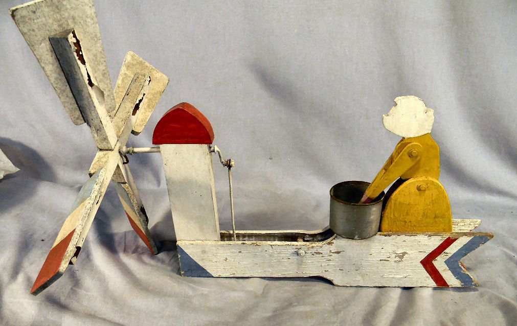 Vintage Folk Art Whirligig of washer woman, old p: Vintage Folk Art Whirligig of washer woman, old paint, operating, good condition with weathering, some paint peeling on blades. 19" long and 14" high.