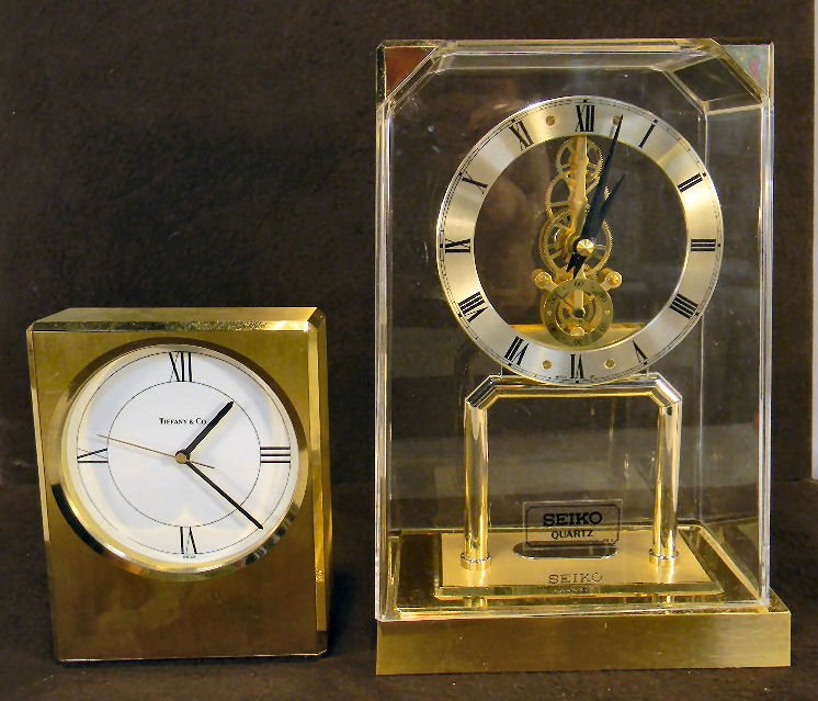 Lot of two quartz clocks including Tiffany & Co. c: Lot of two quartz clocks including Tiffany & Co. clock (working) with brass case and Seiko quartz clock (not operating)