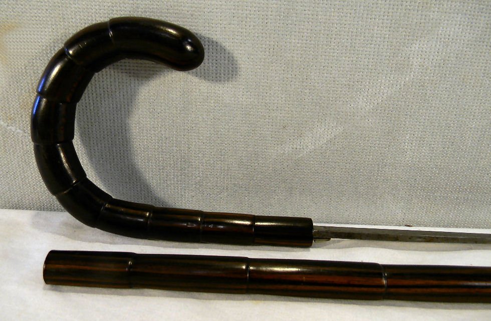 Sword cane with engraved Toledo 27" blade, shaft : Sword cane with engraved Toledo 27" blade, shaft looks to be rosewood and is carved to simulate bamboo. Measures 35.5" overall, bone tip, last half 19th century