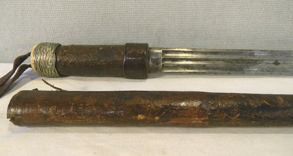 Sword stick cane, shaft is two pieces: Sword stick cane, shaft is two pieces of wood wrapped in leather, bone knob handle is wrapped with wire, 31" long blade with triple fuller, stamped 1852, 35.75" long