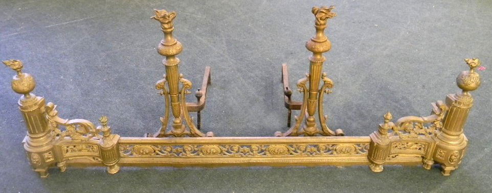 French styled brass andirons with matching brass fender: French styled brass andirons with matching brass fender, andirons measures 22.75" high and 20" front to back, fender measures 60" long, 11.5" front to back.