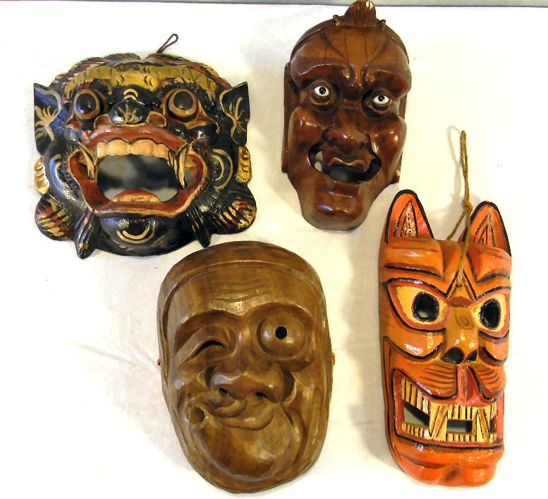 Four Asian Kabuki masks, carved wood, one is signed, on: Four Asian Kabuki masks, carved wood, one is signed, one with glass eyes