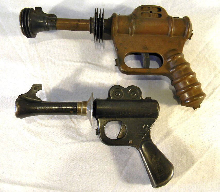 Two Buck Rogers toy pistols manufactured by the Daisy M: Two Buck Rogers toy pistols manufactured by the Daisy Mfg. Co., larger Disintegrator model measures 9.5" long, smaller measures 7.5", light rust, neither operating
