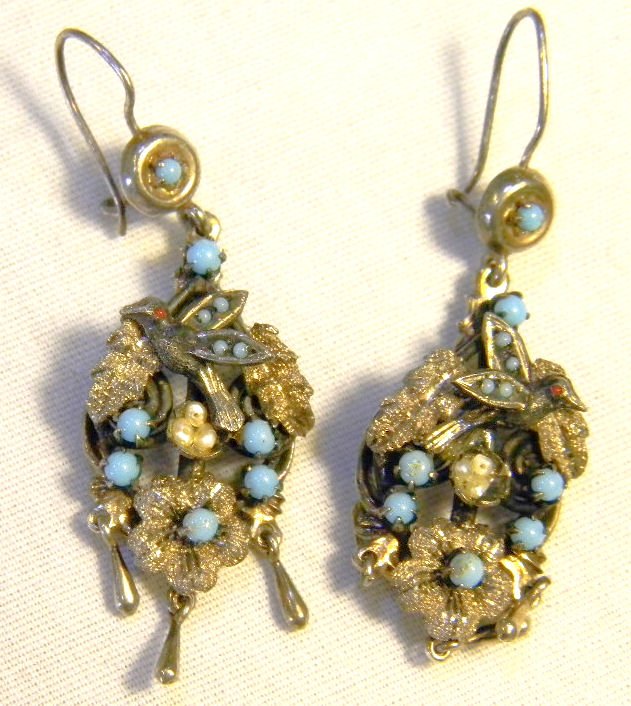 Pair of sterling silver earrings with bird and birds ne: Pair of sterling silver earrings with bird and birds nest, nest with three pearl eggs, turquoise colored beads, fine detail