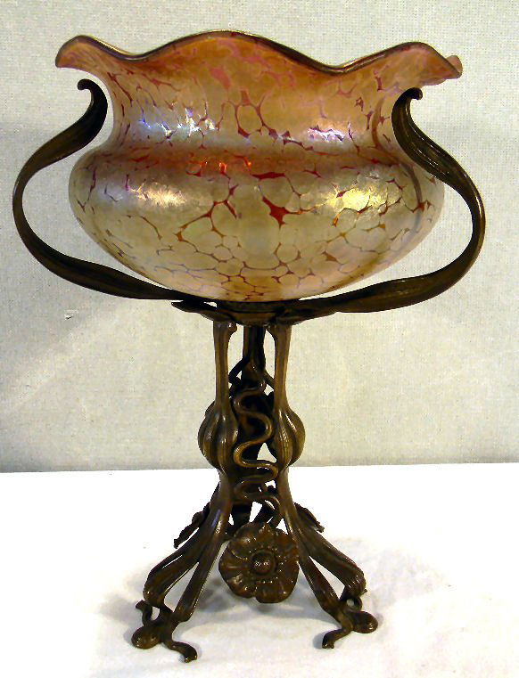 Loetz cranberry colored bowl on art nouveau metal base,: Loetz cranberry colored bowl on art nouveau metal base, 11" overall, bowl measures 6.5" wide and 4" high