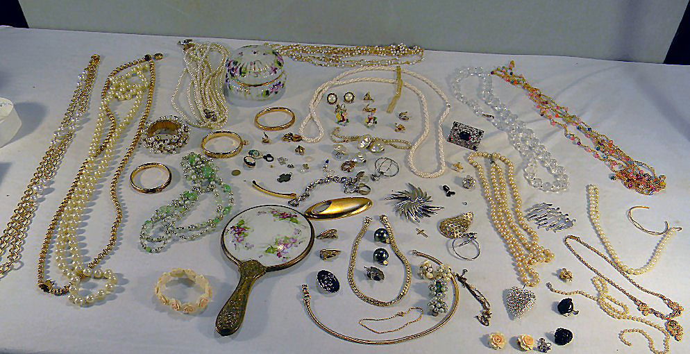 Large lot of misc. costume jewelry including necklaces,: Large lot of misc. costume jewelry including necklaces, bracelets, pins, earrings, brooches, pendants, pins, dresser box and hand mirror