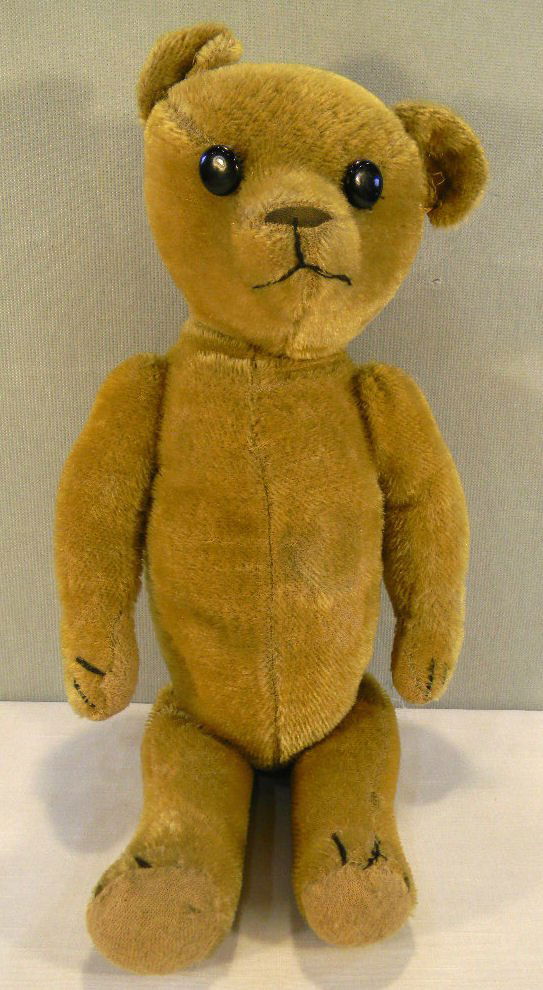 Old straw stuffed Teddy Bear, moving arms, legs and hea