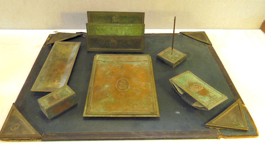 Bronze desk set, no markings, included are blotter corn: Bronze desk set, no markings, included are blotter corners (blotter worn), stamp box, pen tray, pad holder, envelope/stationary holder, ink blotter and note spike. Wear to patina