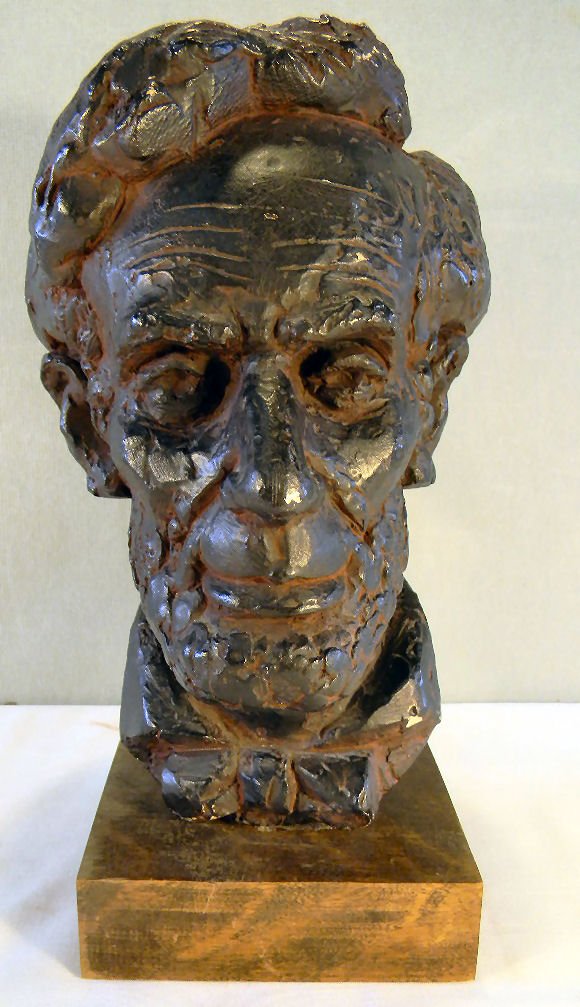 Bust of Abraham Lincoln by Joseph Konzal: Bust of Abraham Lincoln by Joseph Konzal, bronze patinated plaster, 14" high on stand, flakes on patinated surface, signed Konzal on back.