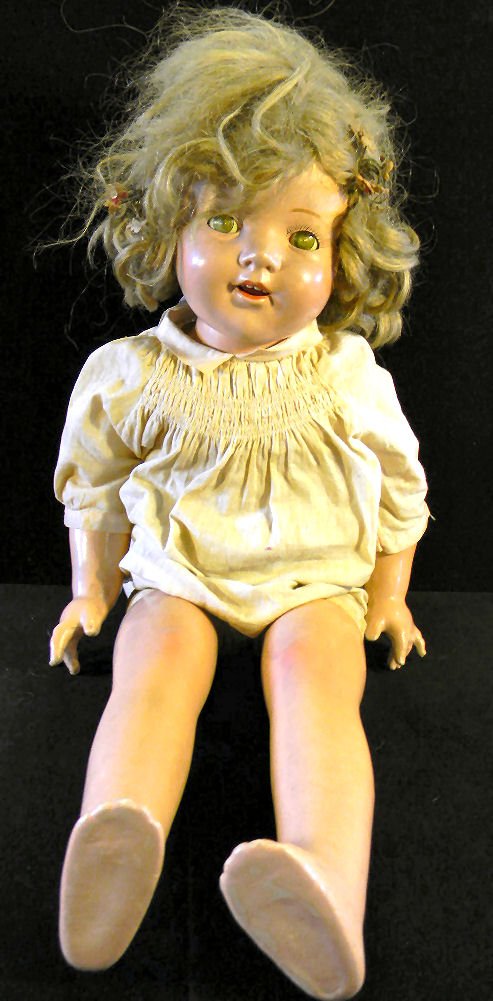 Composition Shirley Temple doll, 29" long, unmarked, li: Composition Shirley Temple doll, 29" long, unmarked, light crazing on face and limbs, eyes discolored, no cracks or breaks, squeaker box not working, no damage to fingers