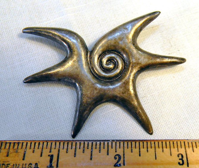 William Spratling sterling silver pin, 2 7/8" across, .: William Spratling sterling silver pin, 2 7/8" across, .77 troy ounces, slight bend at tip of one arm, pin catch broken, surface scratches, marked with oval mark and partial circle mark, 1940's