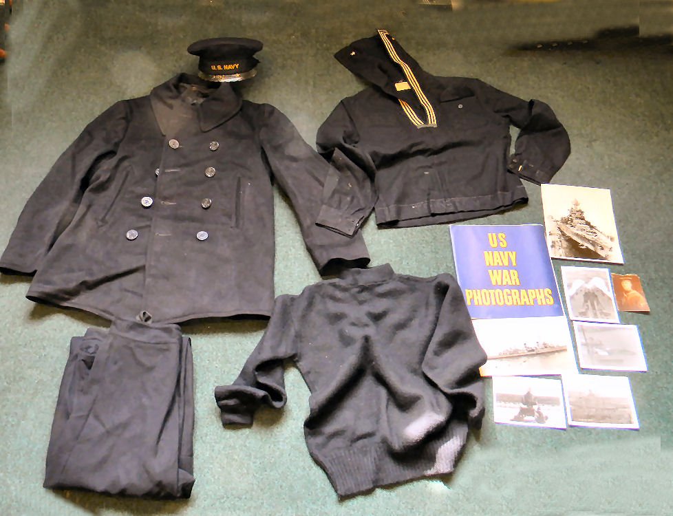 Lot of U.S. Navy items including WWII or earlier unifor: Lot of U.S. Navy items including WWII or earlier uniform including hat, shirt, coat, sweater, pants together with WWII banner, photo book and individual photos