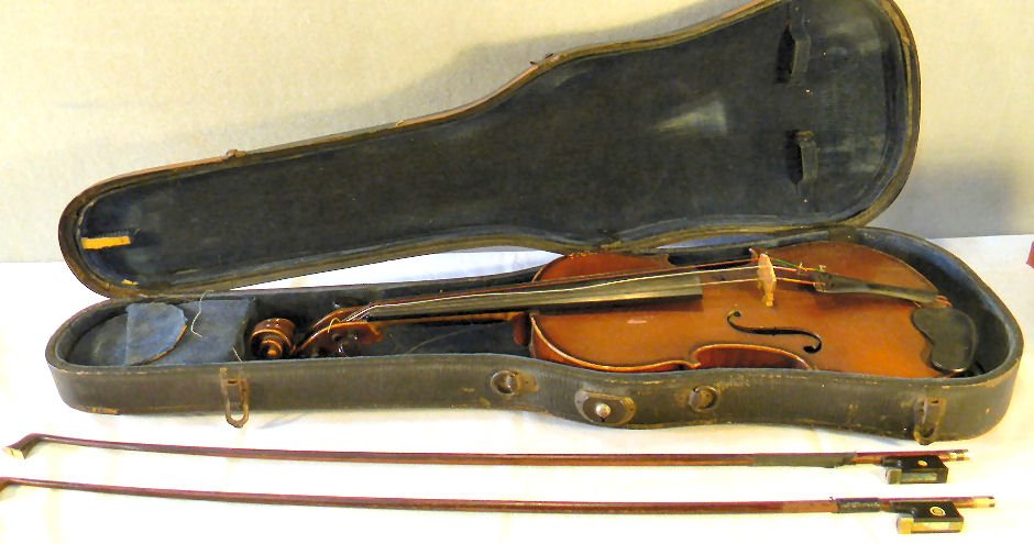 Estate violin labeled "Copy of Stradivarius": Estate violin labeled "Copy of Stradivarius", back is also maker branded (see photo), no cracks or breaks, some wear to finish on edges, measures 23.5" long. Case is rough, no handle. Comes with two b