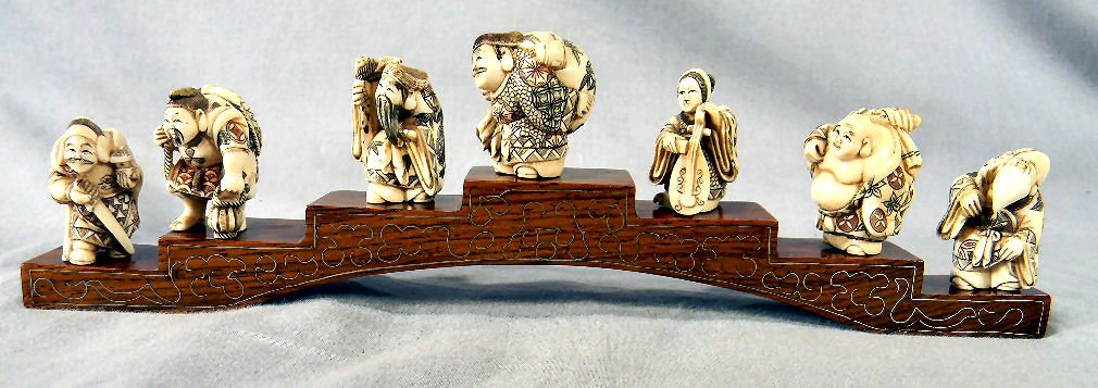 Set of seven signed Japanese netsuke with rosewood: Set of seven signed Japanese netsuke with rosewood bridge (some wire inlay loose), all in excellent condition