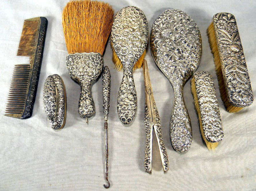 Gorham sterling silver reposse' dresser set: Gorham sterling silver reposse' dresser set including four brushes, hand mirror, comb (damaged teeth), nail buffer and glove stretcher (monogram). Button hook is not sterling and does no match