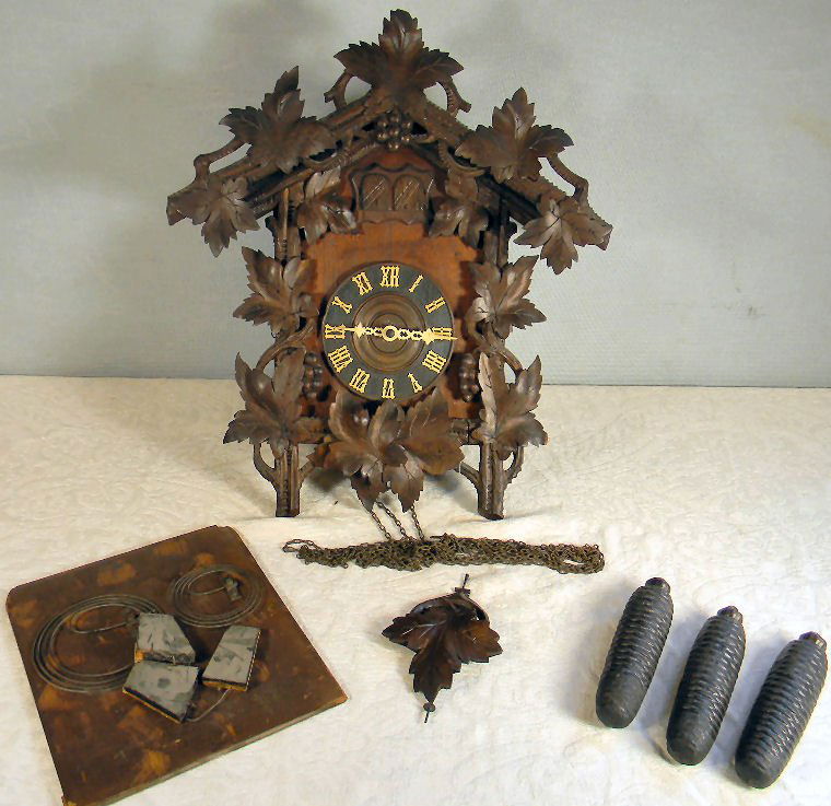 Carved German cuckoo clock marked "Made in Germany",: Carved German cuckoo clock marked "Made in Germany", 21" high case, two birds, original pendulum and weights, bellows need work or replacing, original label on back panel