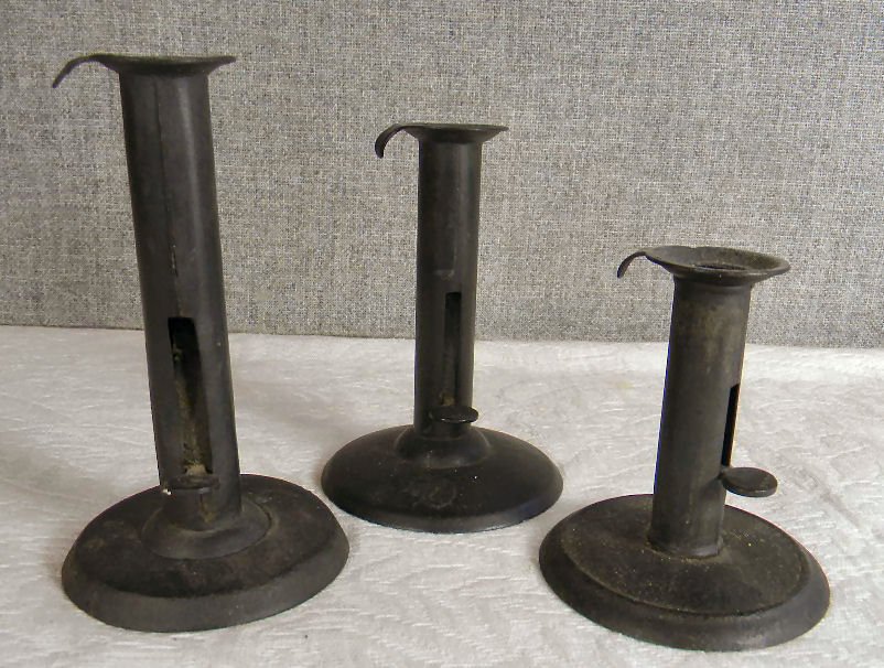 Lot of three hog scrapper adjustable candle holders: Lot of three hog scrapper adjustable candle holders, 4.25" to 6.25" high, shortest has what looks to be an 1855 patent date on finger lift, small break at top