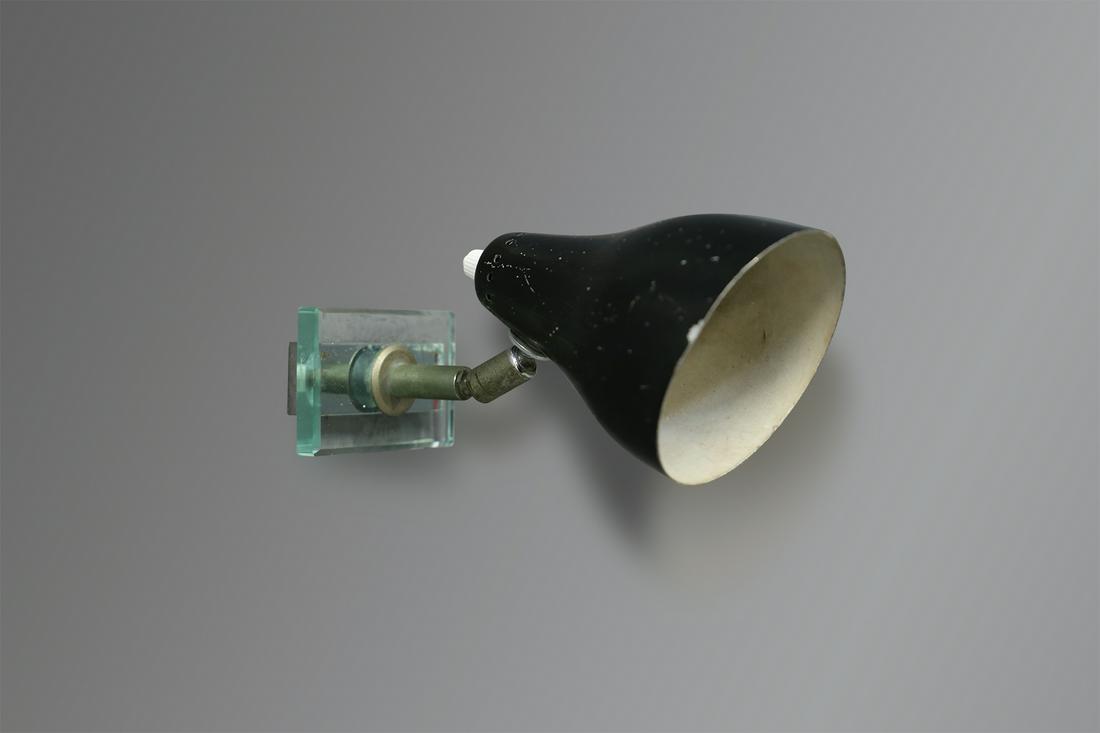 Wall Lamp Angelo Ostuni Black Midcentury for Oluce: Wall sconce designed by Angelo Ostuni for Oluce in 1960. The light is composed of one light their cap is in painted aluminium conical shaped. The light is anchored to the wall by a thick glass sheet.