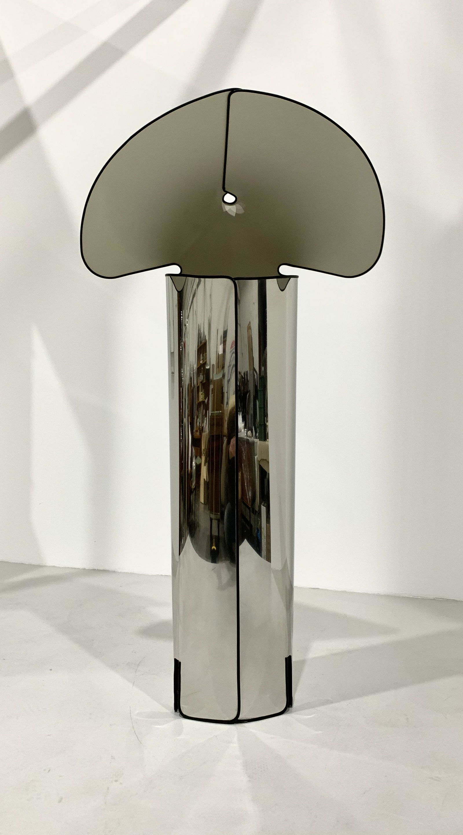 Mario Bellini - Chiara Floor Lamp for Flos, 1967: Width 72 cm Depth 52 cm Height 142 cm. This floor lamp is made from a single sheet of stainless steel, cut and bent to form both the base and the diffuser.