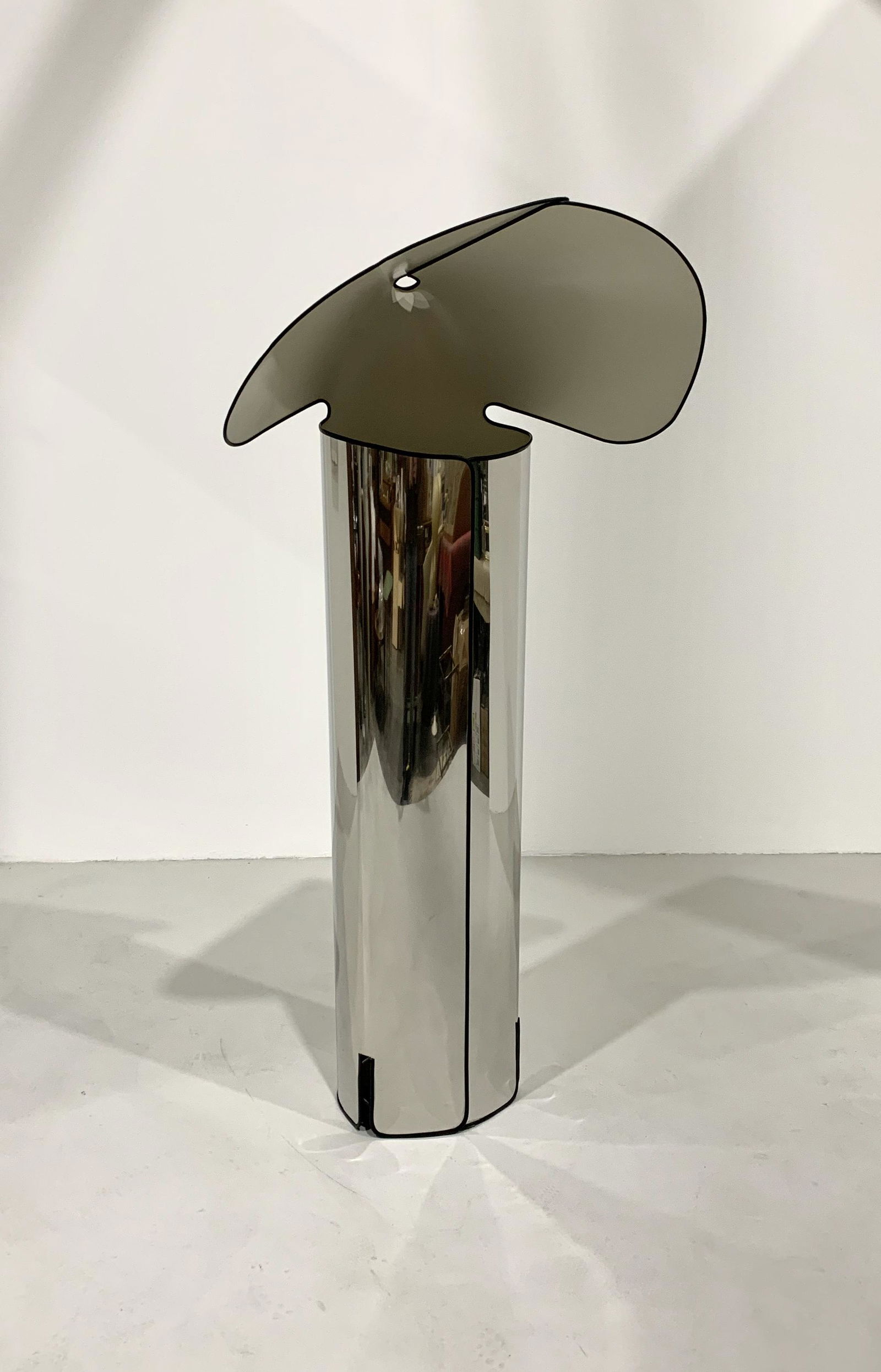 Mario Bellini - Chiara Floor Lamp for Flos, 1967: Width 72 cm Depth 52 cm Height 142 cm. This floor lamp is made from a single sheet of stainless steel, cut and bent to form both the base and the diffuser.