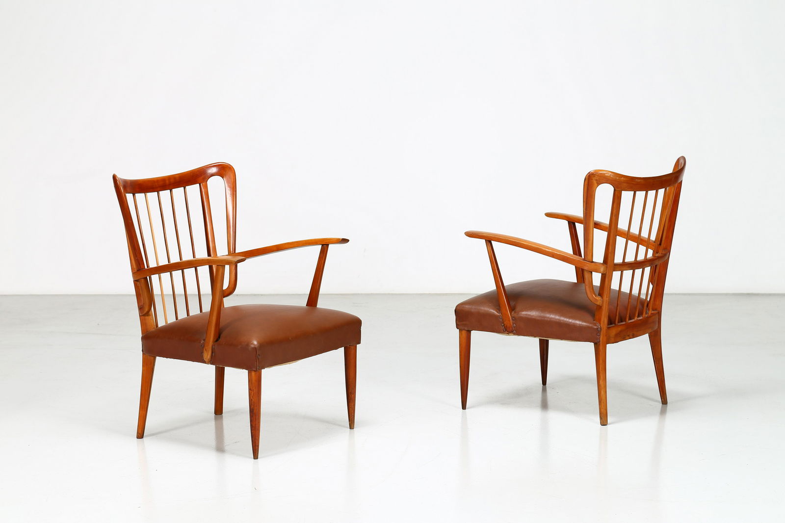Paolo Buffa Pair of Midcentury Chairs in Cherrywood and: Beautiful pair of chairs made by Paolo Buffa in 1950. The seats have a cherrywood structure in beautiful patina, while the seat is in beautiful burgundy leather. The backrest is made of 7 strips of wo