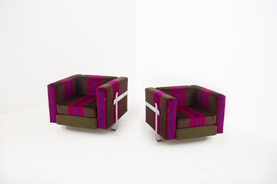 Kazuhide Takahama Armchairs: height: 70 cm width: 88 cm depth: 86 cm seat height: 29 cm Beautiful pair of armchairs with anodized aluminum frame.Brown, fuchsia, and purple striped fabric. The cushions serve as square armrests. Si