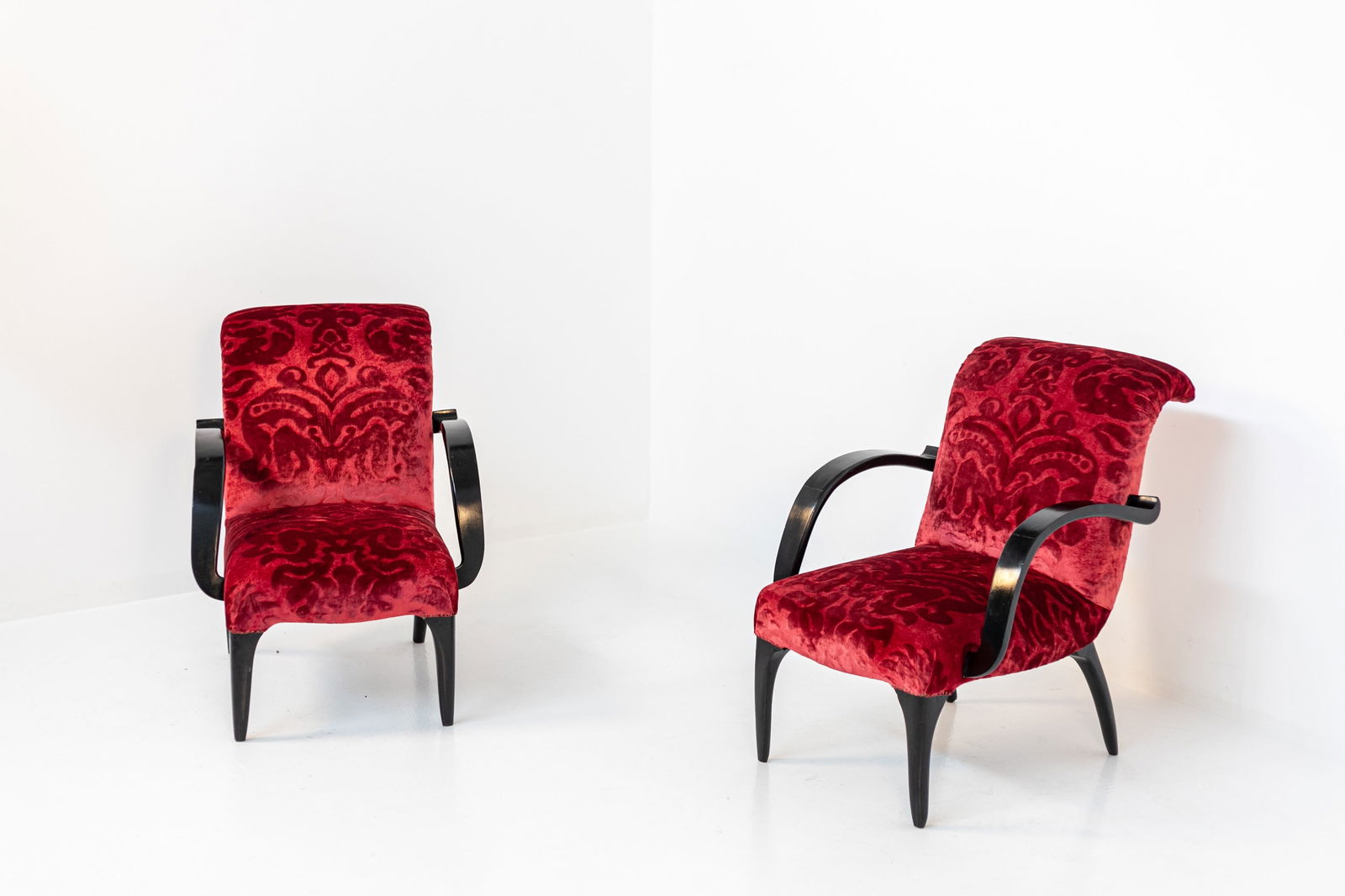 Gilbert Rohdes Pair of Armchairs (Attr.): Height: 82 cm Width: 64 cm Depth: 74 cm Seat Height: 41 cmExtraordinary pair of American armchairs from the 1930s attributed to the designer . The pair of armchairs are made of very elegant red damask