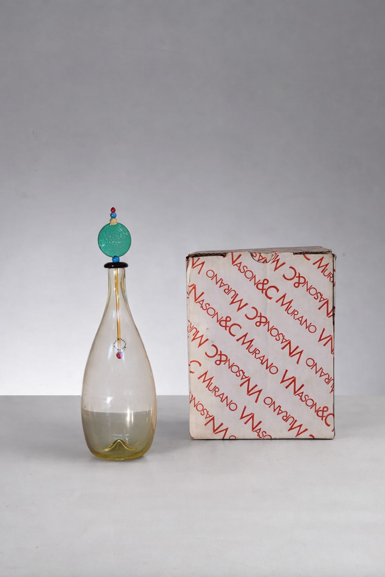 Carlo Nason Artistic Murano Bottle, label: Height 29 cm, diameter 8.5 cmArtistic Murano glass bottle by Carlo Nason from the 1980s. With original label and box.