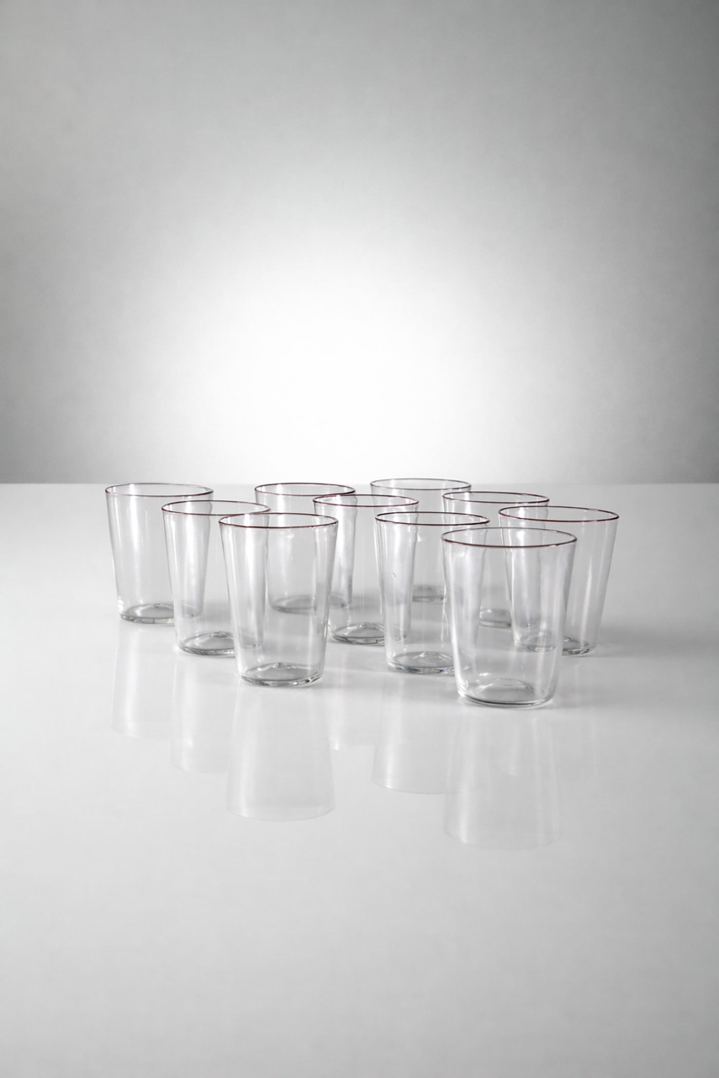 Carlo Scarpa Set glasses: Height 8 cm, diameter 10.5 cmSet of 10 Carlo Scarpa glasses, Venini production, Cappelin with amethyst red rim, late 1920s.