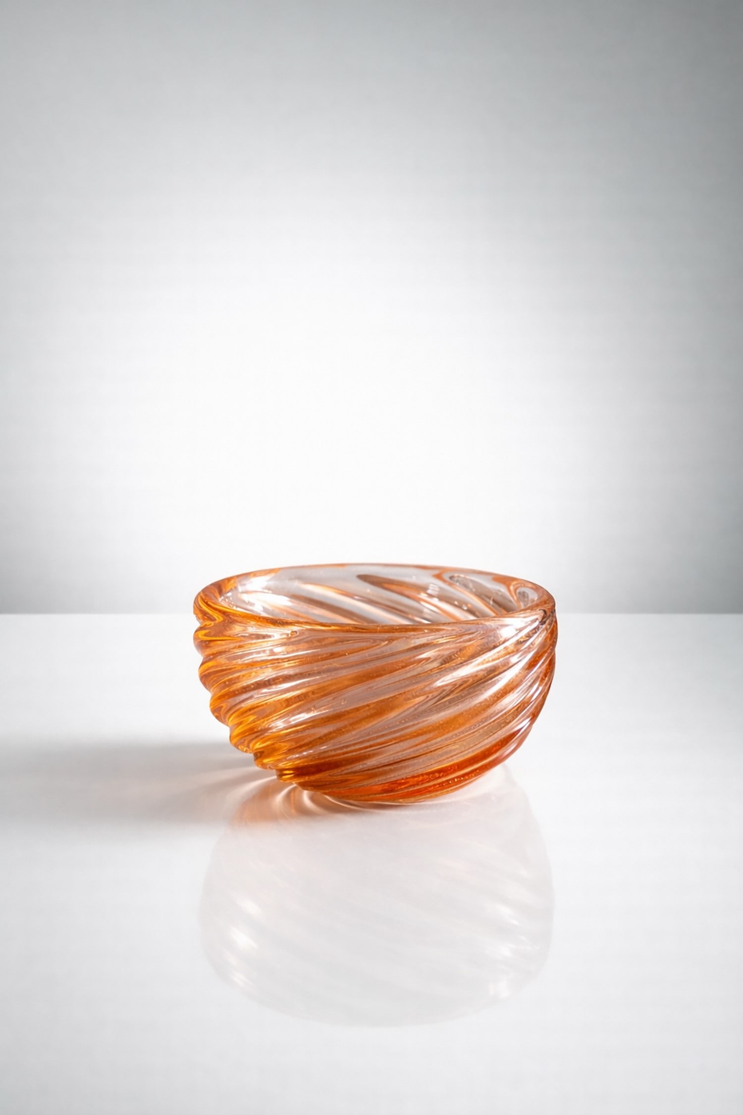 Carlo Scarpa Glass cup, signed: Height 6 cm, diameter 12 cmGlass cup by Paolo Scarpa, 1930s, "Diamante", with a polylobed section, pink in color, produced by Venini. Venini acid signature