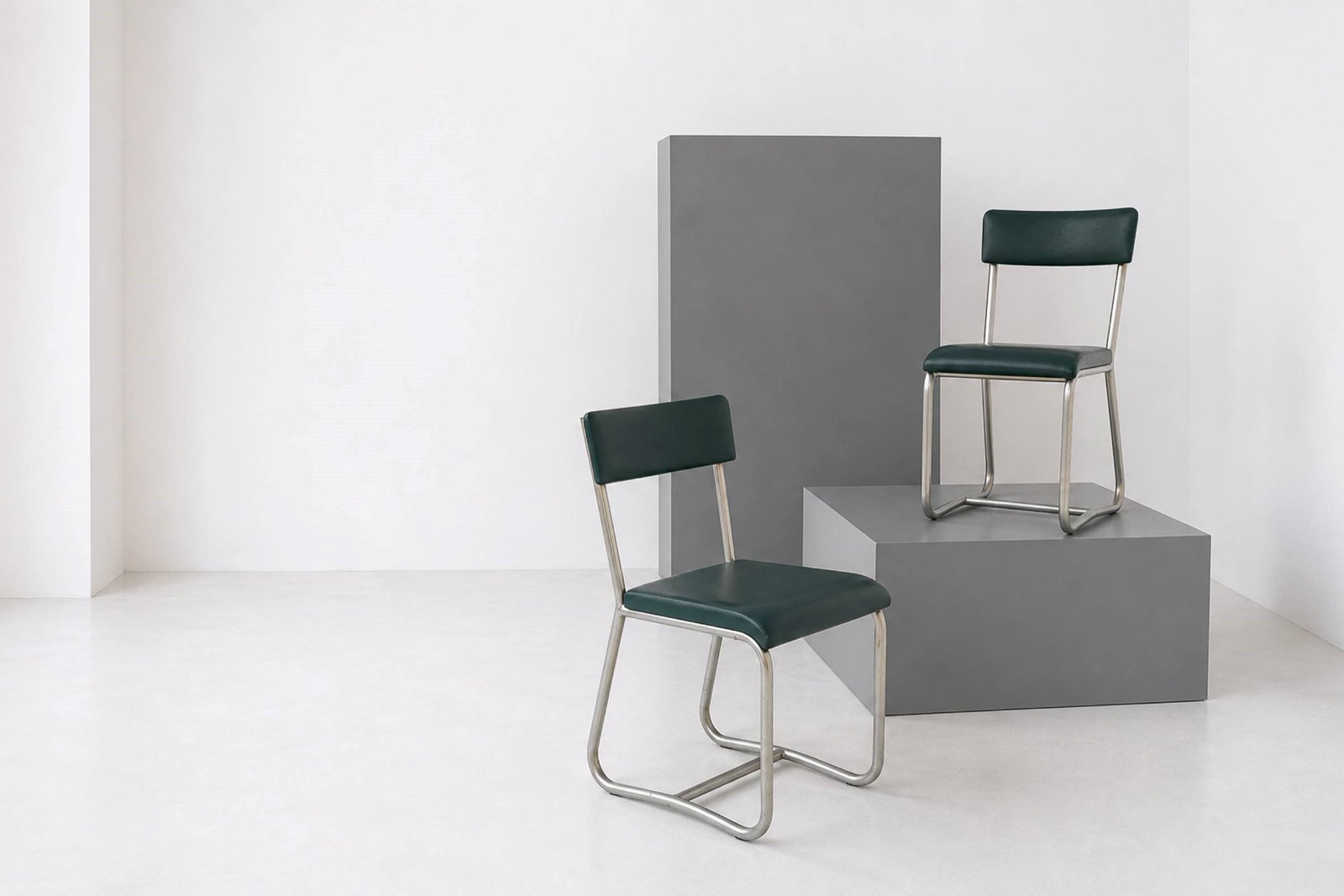 Manifattura Italiana Pair of chairs: Height: cm 85 Width: cm 43 Depth: cm 46 Pair of Italian-made chairs in tubular metal and green faux leather, in the Rationalist style